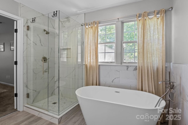 10327 Shelter Rock Ct, Charlotte, NC 28214 - full bath featuring a freestanding tub, a marble finish shower, wood finished floors, and tile walls