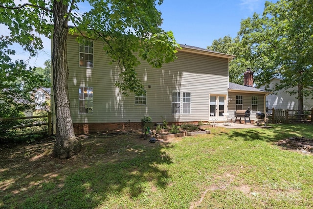 10327 Shelter Rock Ct, Charlotte, NC 28214 - back of house featuring a patio, a chimney, and a garden