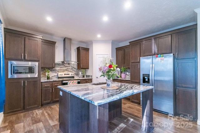 1811 Continental Dr, Albemarle, NC 28001 - kitchen with wall chimney exhaust hood, appliances with stainless steel finishes, light stone countertops, a center island, and decorative backsplash