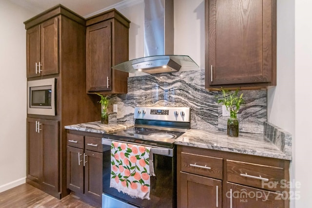 1811 Continental Dr, Albemarle, NC 28001 - kitchen featuring wall chimney range hood, stainless steel appliances, backsplash, wood finished floors, and light stone countertops