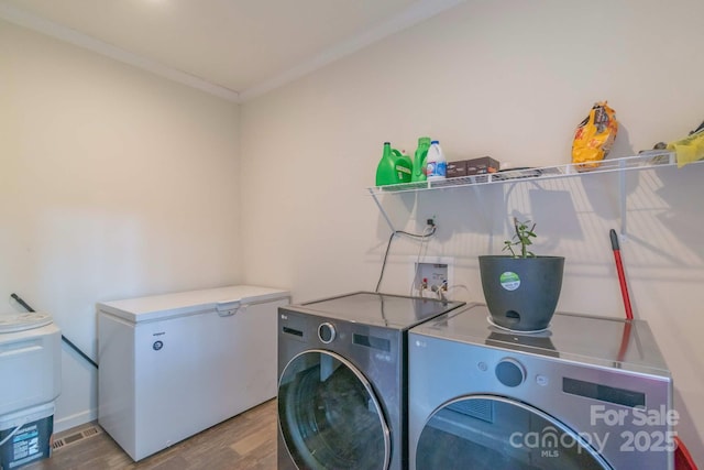 1811 Continental Dr, Albemarle, NC 28001 - washroom featuring separate washer and dryer, wood finished floors, and crown molding