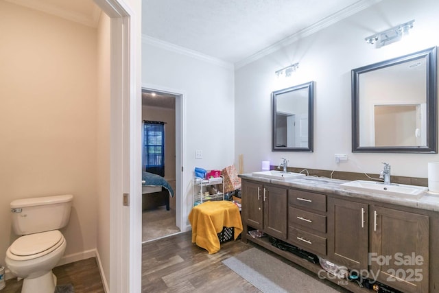 1811 Continental Dr, Albemarle, NC 28001 - full bathroom with wood finished floors, double vanity, crown molding, toilet, and ensuite bathroom