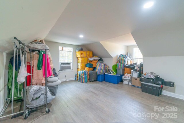 1811 Continental Dr, Albemarle, NC 28001 - bonus room with wood finished floors, vaulted ceiling, plenty of natural light, baseboards, and cooling unit