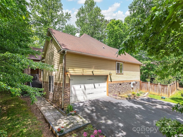 4 Alsatian Ln, Asheville, NC 28805 - view of side of property with stone siding, asphalt driveway, and a shingled roof