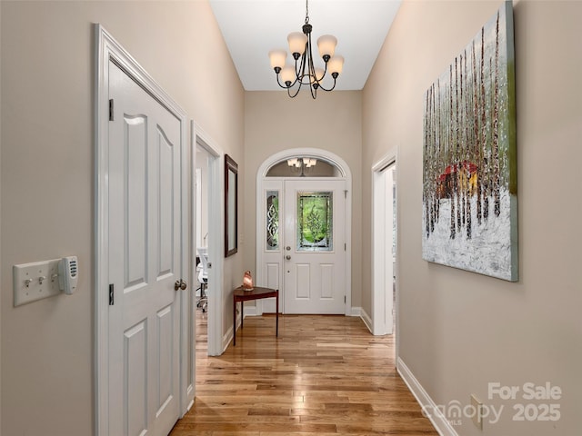 4 Alsatian Ln, Asheville, NC 28805 - entryway with a chandelier, light wood-type flooring, and baseboards