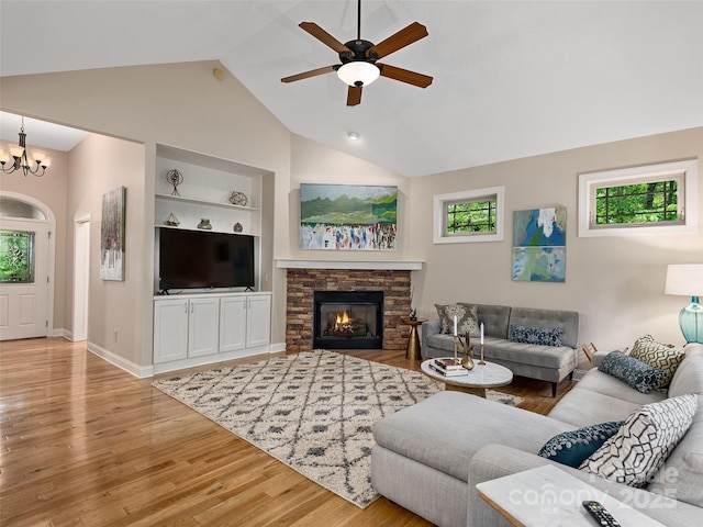 4 Alsatian Ln, Asheville, NC 28805 - living area with healthy amount of natural light, ceiling fan, built in shelves, wood finished floors, and high vaulted ceiling