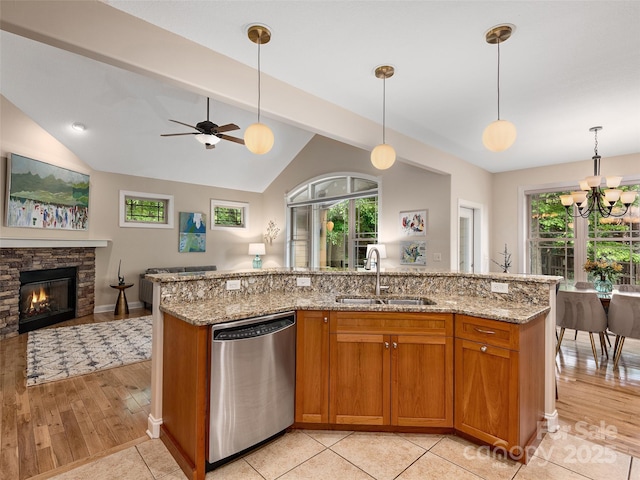 4 Alsatian Ln, Asheville, NC 28805 - kitchen featuring stainless steel dishwasher, a sink, open floor plan, lofted ceiling, and brown cabinetry