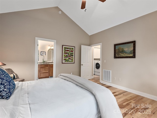 4 Alsatian Ln, Asheville, NC 28805 - bedroom with washer / dryer, high vaulted ceiling, light wood finished floors, connected bathroom, and baseboards