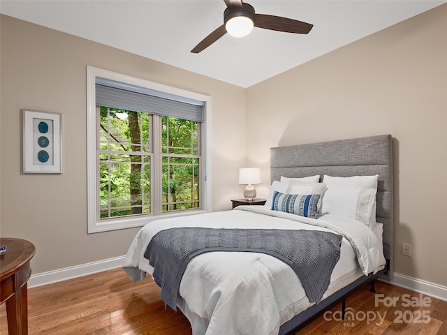 4 Alsatian Ln, Asheville, NC 28805 - bedroom featuring baseboards, wood finished floors, and ceiling fan