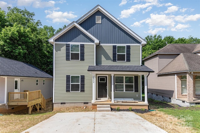 view of front of home with crawl space, board and batten siding, and a porch