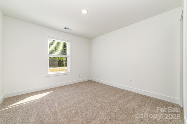 unfurnished room featuring light colored carpet, baseboards, and recessed lighting