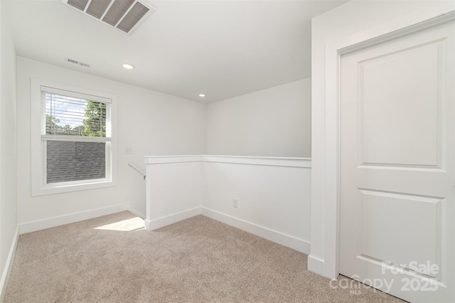 spare room featuring carpet flooring, baseboards, and recessed lighting