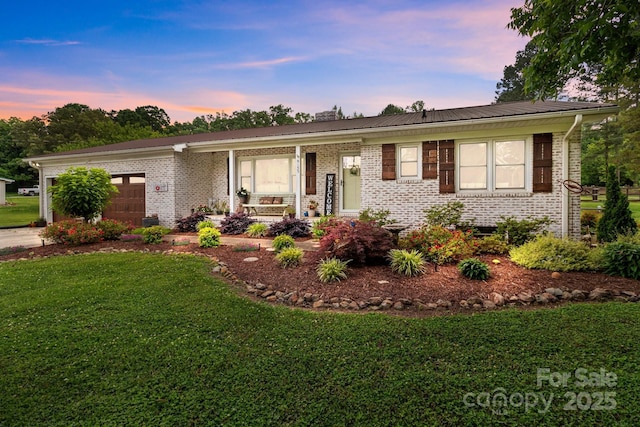 9135 Stokes Ferry Rd, Salisbury, NC 28146 - ranch-style house featuring an attached garage, a front yard, metal roof, and brick siding