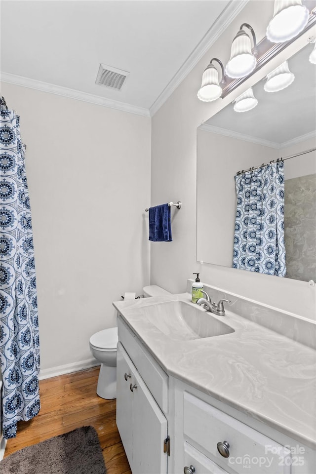 full bath featuring wood finished floors, ornamental molding, toilet, vanity, and curtained shower