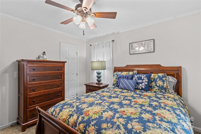 carpeted bedroom with baseboards, crown molding, and a ceiling fan