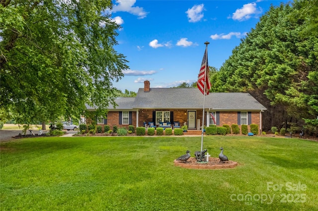 single story home featuring a front lawn, a chimney, and brick siding