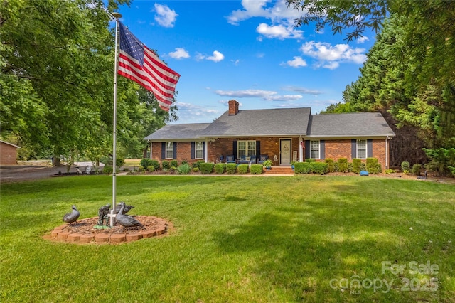 ranch-style house featuring a porch, a front lawn, a chimney, and brick siding