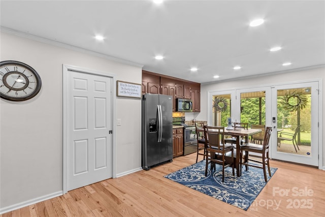 kitchen featuring stainless steel appliances, crown molding, light wood-style floors, french doors, and recessed lighting