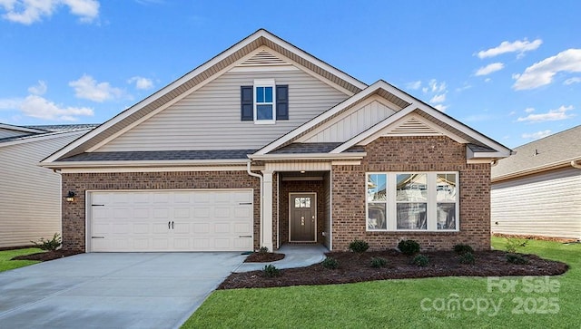 view of front facade featuring brick siding, concrete driveway, and a front lawn