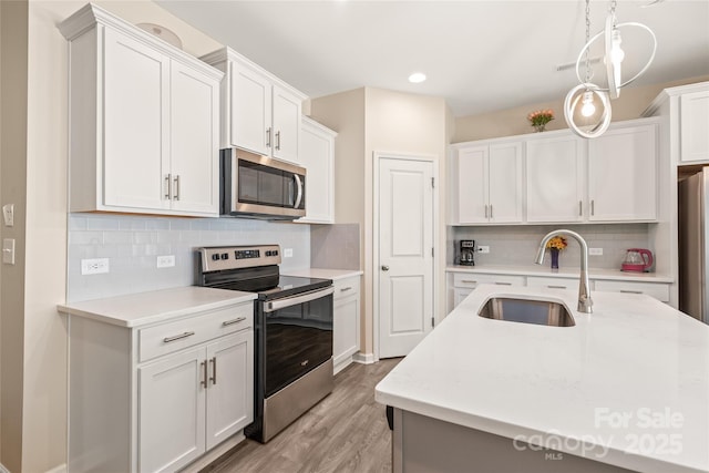13221 Gadwal Pintail Dr, Charlotte, NC 28262 - kitchen with appliances with stainless steel finishes, a sink, light countertops, light wood-type flooring, and recessed lighting