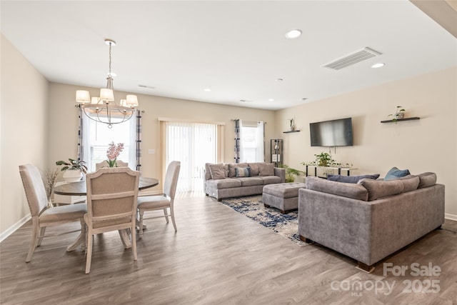 13221 Gadwal Pintail Dr, Charlotte, NC 28262 - living area featuring a chandelier, wood finished floors, baseboards, and recessed lighting