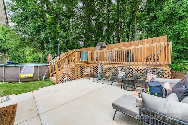 107 Oakland Rd, Belmont, NC 28012 - view of patio featuring a wooden deck, an outdoor pool, outdoor lounge area, view of scattered trees, and stairway
