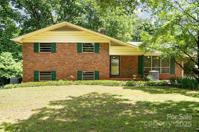 52 September Ct, Concord, NC 28025 - split level home featuring central AC, a front yard, brick siding, and a chimney
