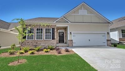 craftsman-style home with brick siding, concrete driveway, board and batten siding, and a front lawn