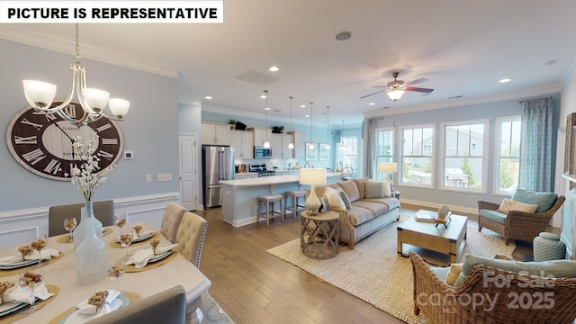living area featuring a chandelier, ornamental molding, dark wood-style flooring, a ceiling fan, and recessed lighting