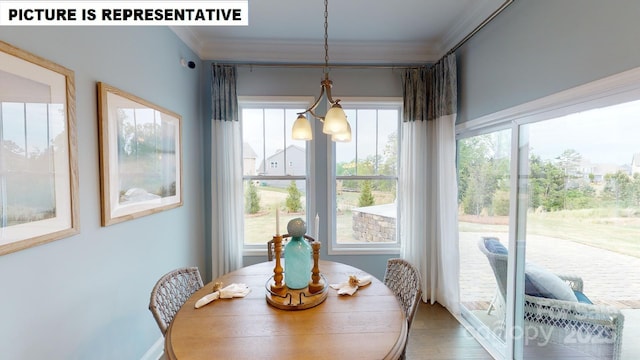 dining space featuring ornamental molding and wood finished floors
