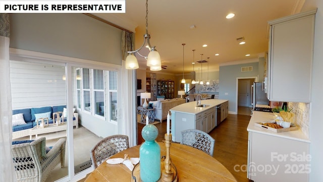 dining area with crown molding, a chandelier, recessed lighting, and dark wood-style floors