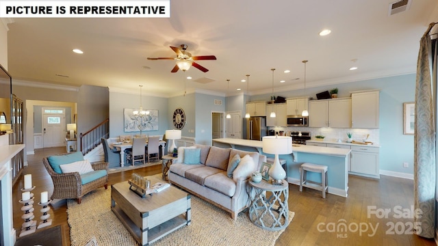 living room featuring a chandelier, stairway, wood finished floors, a ceiling fan, and recessed lighting