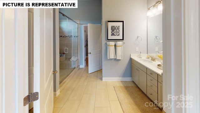 full bathroom with a shower stall, baseboards, and double vanity
