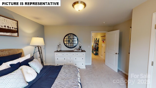 bedroom with light carpet and baseboards