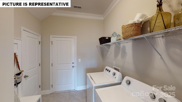 laundry room featuring washing machine and clothes dryer, ornamental molding, light tile patterned flooring, and baseboards
