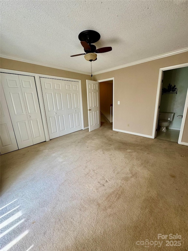 303 Eastwood Dr, Salisbury, NC 28146 - unfurnished bedroom featuring carpet flooring, ornamental molding, multiple closets, baseboards, and connected bathroom