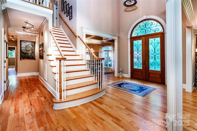 122 Sleepy Cove Trl, Mooresville, NC 28117 - entrance foyer featuring stairs, baseboards, wood finished floors, crown molding, and a high ceiling