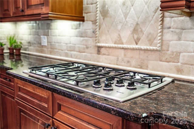 122 Sleepy Cove Trl, Mooresville, NC 28117 - kitchen featuring stainless steel gas stovetop, decorative backsplash, and dark stone countertops