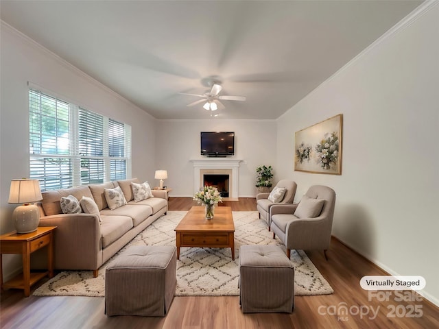 10319 Willingham Rd, Huntersville, NC 28078 - living area with a ceiling fan, ornamental molding, wood finished floors, and a fireplace