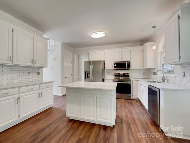 10319 Willingham Rd, Huntersville, NC 28078 - kitchen featuring appliances with stainless steel finishes, a sink, decorative backsplash, dark wood-style flooring, and white cabinetry