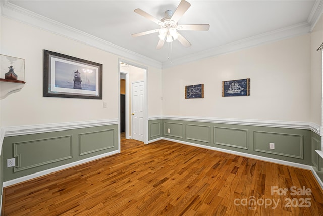220 Glenville Dr, Fort Mill, SC 29715 - spare room with ornamental molding, wood finished floors, ceiling fan, wainscoting, and a decorative wall
