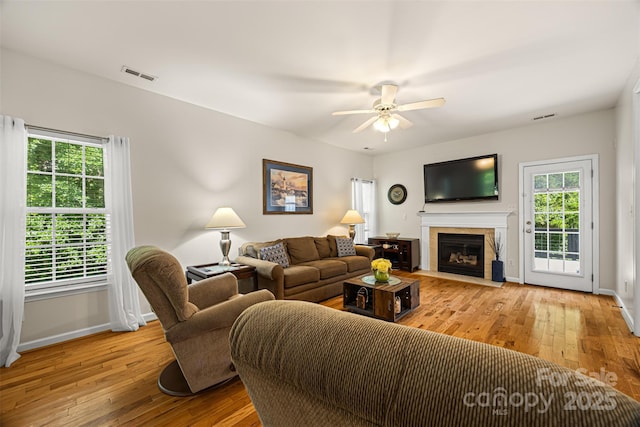220 Glenville Dr, Fort Mill, SC 29715 - living area featuring hardwood / wood-style floors, a ceiling fan, and a fireplace with flush hearth
