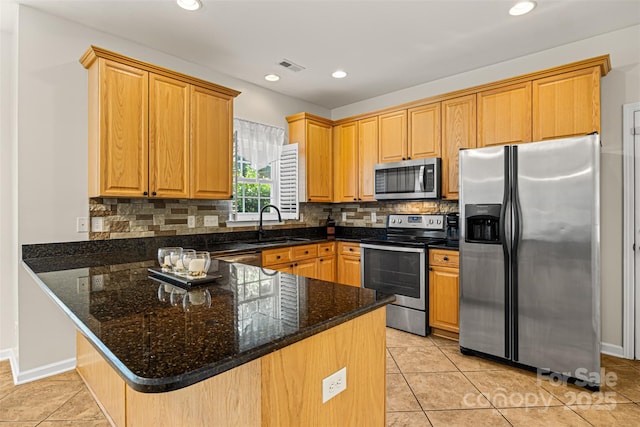 220 Glenville Dr, Fort Mill, SC 29715 - kitchen with appliances with stainless steel finishes, a peninsula, backsplash, light tile patterned flooring, and recessed lighting