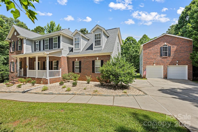 220 Glenville Dr, Fort Mill, SC 29715 - traditional-style house with covered porch, concrete driveway, a garage, brick siding, and a front yard