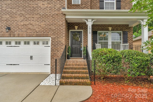 1919 Madeira Cir, Waxhaw, NC 28173 - doorway to property with brick siding, concrete driveway, and covered porch
