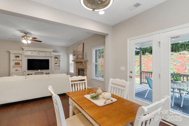 1919 Madeira Cir, Waxhaw, NC 28173 - dining room with a stone fireplace, dark wood finished floors, and a ceiling fan