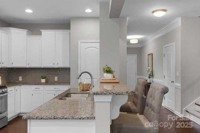 1919 Madeira Cir, Waxhaw, NC 28173 - kitchen featuring a sink, light stone countertops, dark wood finished floors, white cabinets, and recessed lighting