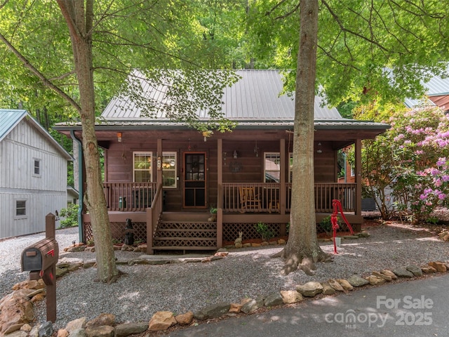 41 Trapper Ln, Waynesville, NC 28785 - rustic home with a porch and metal roof
