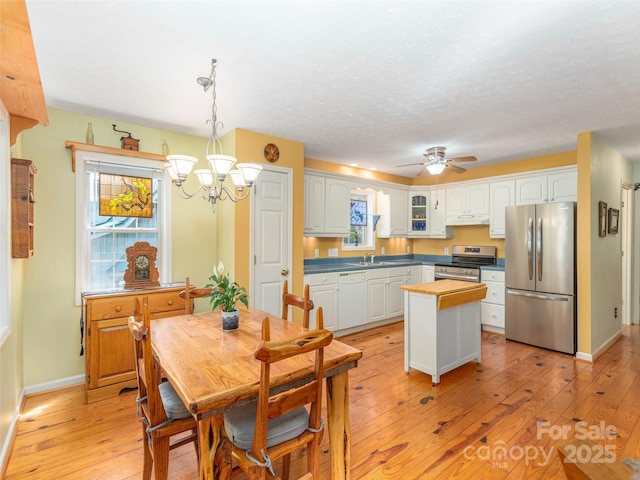 41 Trapper Ln, Waynesville, NC 28785 - kitchen with appliances with stainless steel finishes, light wood-style flooring, a sink, white cabinets, and a textured ceiling