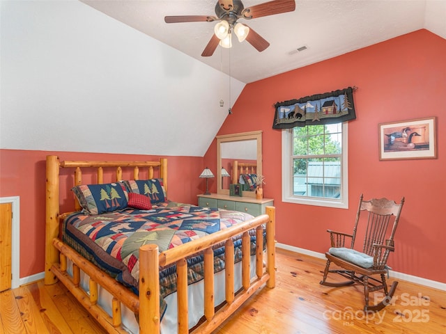 41 Trapper Ln, Waynesville, NC 28785 - bedroom with light wood-style flooring, vaulted ceiling, baseboards, and a ceiling fan